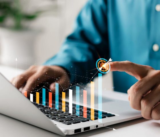 Businessman analyzing company's financial balance sheet working with digital augmented reality graphics. Businessman calculates financial data for long-term investment.
